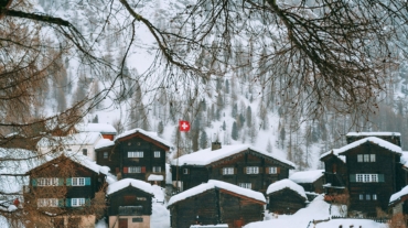 snowy village houses on hilly terrain