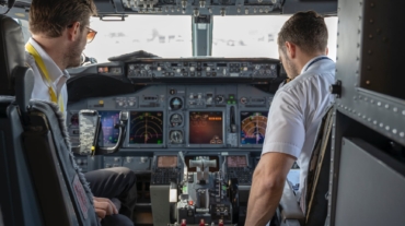 two pilots sitting inside plane